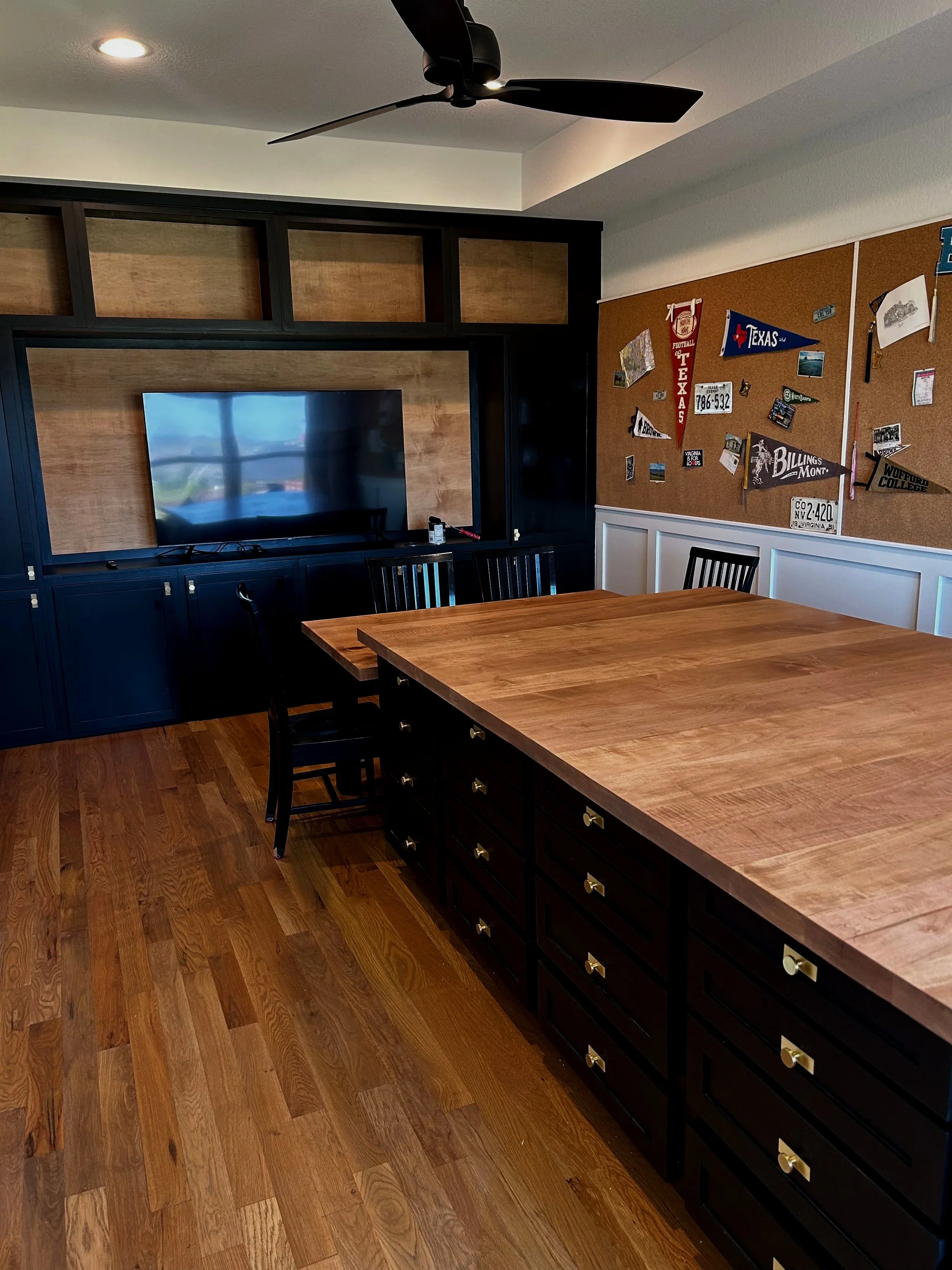 Built in entertainment center in a craft room. craft room island craft room built ins, black and wood bulitins black and wood built in cabinets. Specialty built craft room