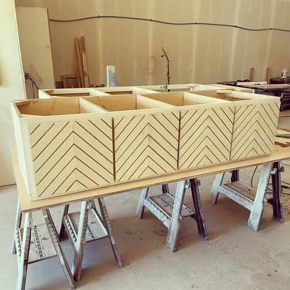 Built in bench for kitchen nook with chevron doors. Chevron design on cabinets doors. Wood cabinets with chevron design.