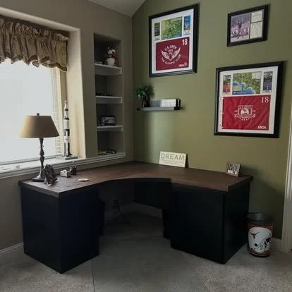 Built in solid oak desk top. two custom black cabinets and a rounded part of the L shaped desk 