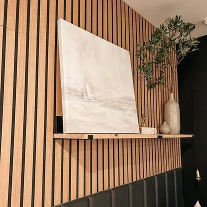 Solid wood alder shelf over bed in a bedroom. Wood paneling on the wall 