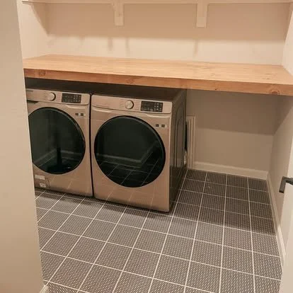 Solid wood built in counter top over front loading washer and dryer. 