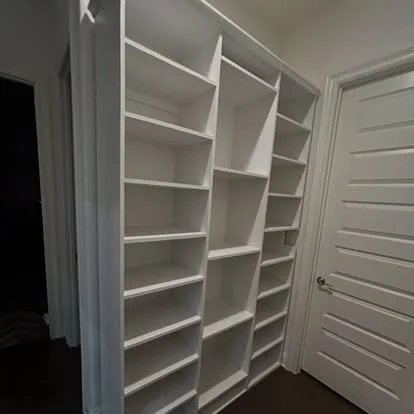 White built in shoes storage in mudroom area. White wood built in for shoe storage in mud room.