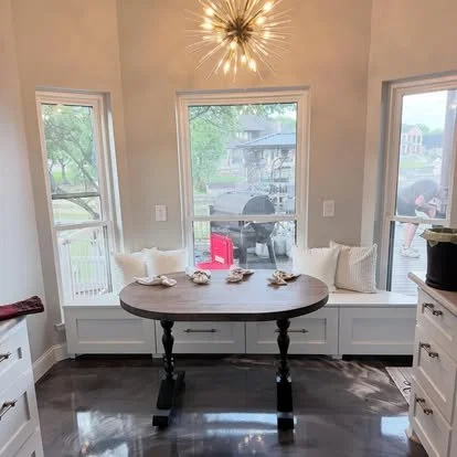 Built in breakfast nook seating and table. Bay window custom seating with drawer storage. solid maple oval table for kitchen nook.