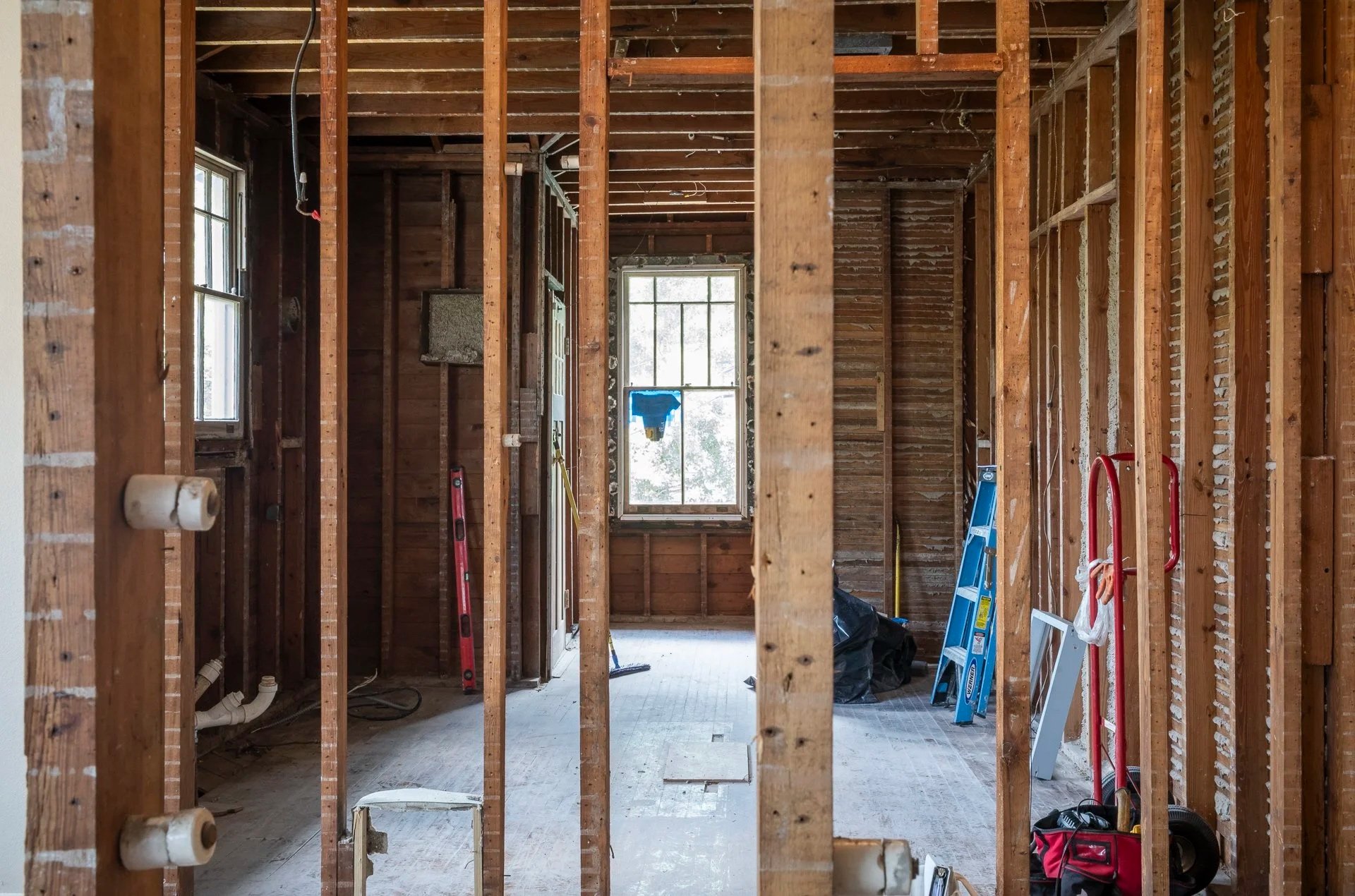 Kitchen renovation construction phase in New Orleans showing unfinished layout and electrical work