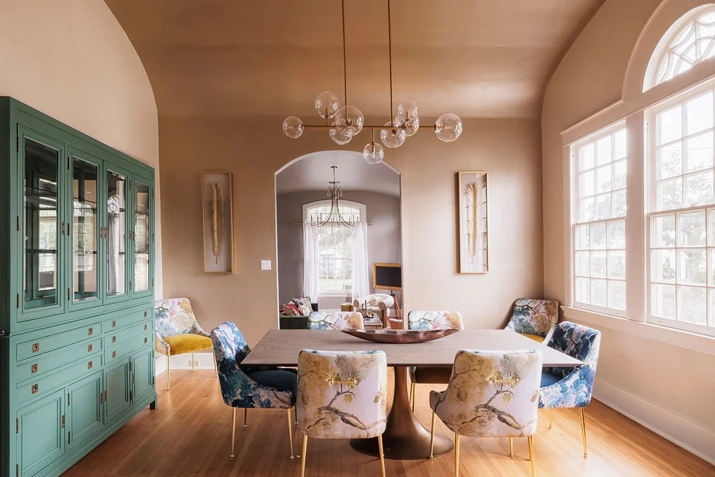 Dining room with arched window and teal hutch