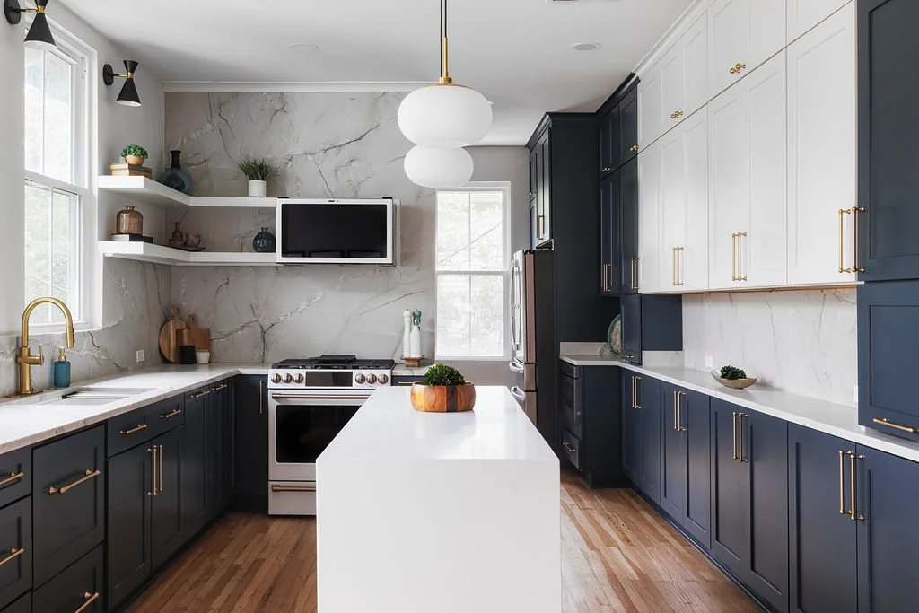 Opened-up kitchen with navy cabinets in an Uptown New Orleans home