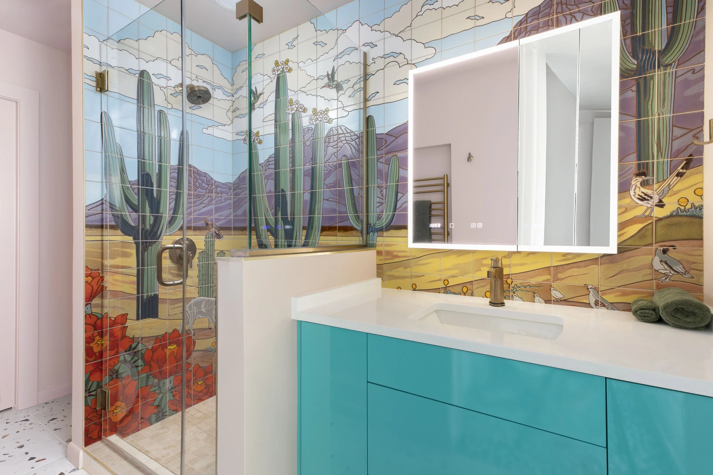 Custom desert mural tile bathroom with turquoise vanity in New Orleans home by Val Spaces