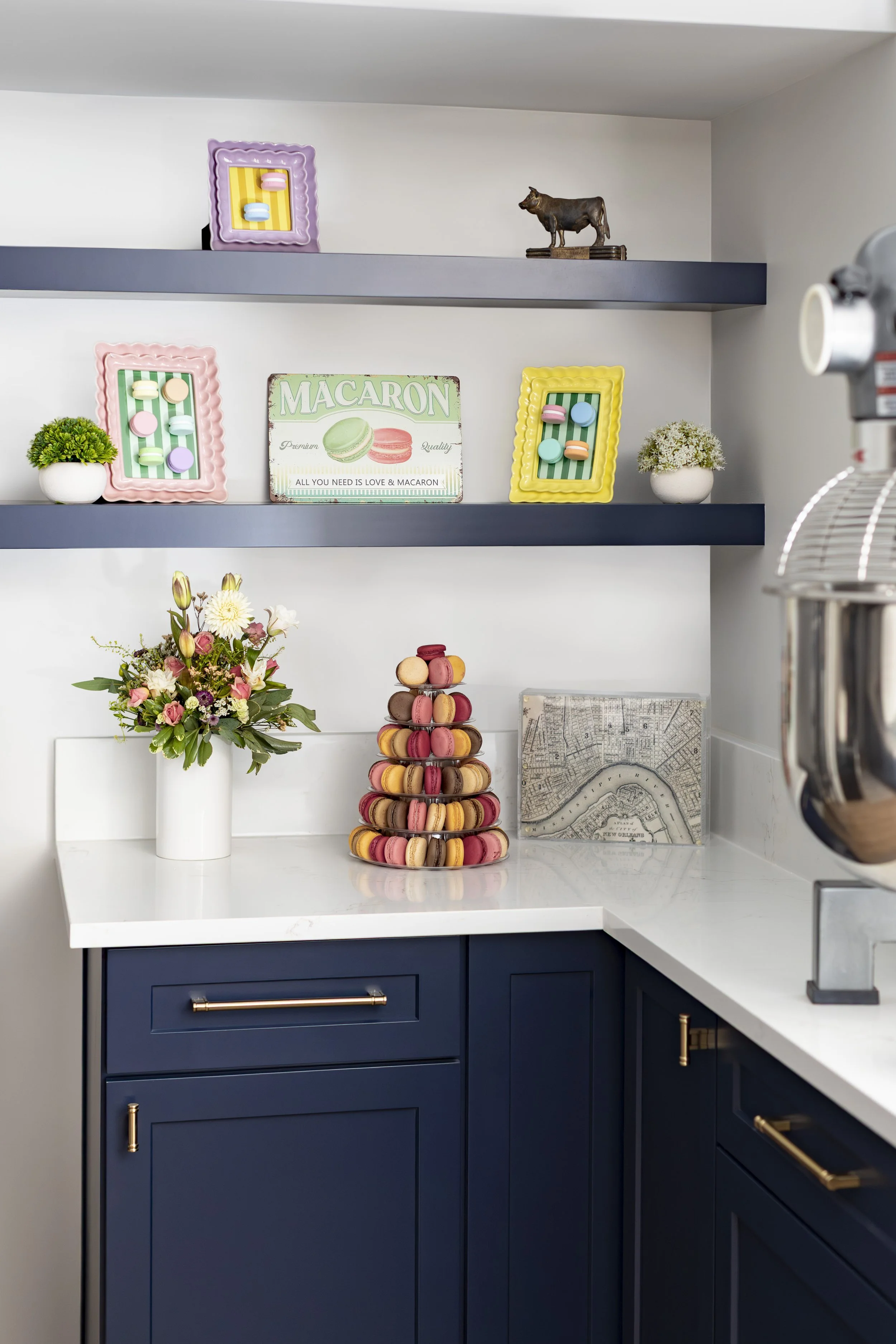 Navy floating shelves displaying the homeowner's macarons