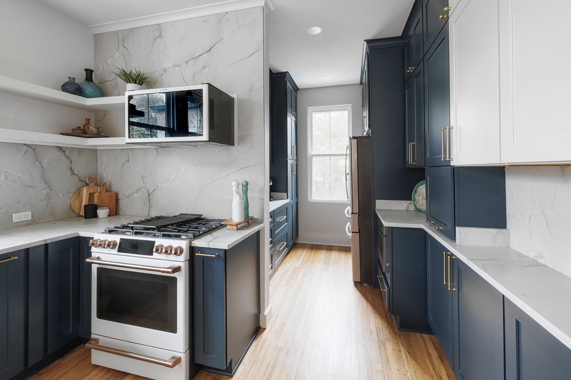 Styled kitchen corner with marble countertop, decorative accessories, and custom cabinetry in New Orleans home