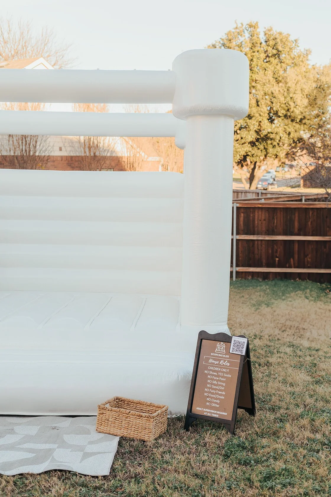 A bounce house with a sign and basket