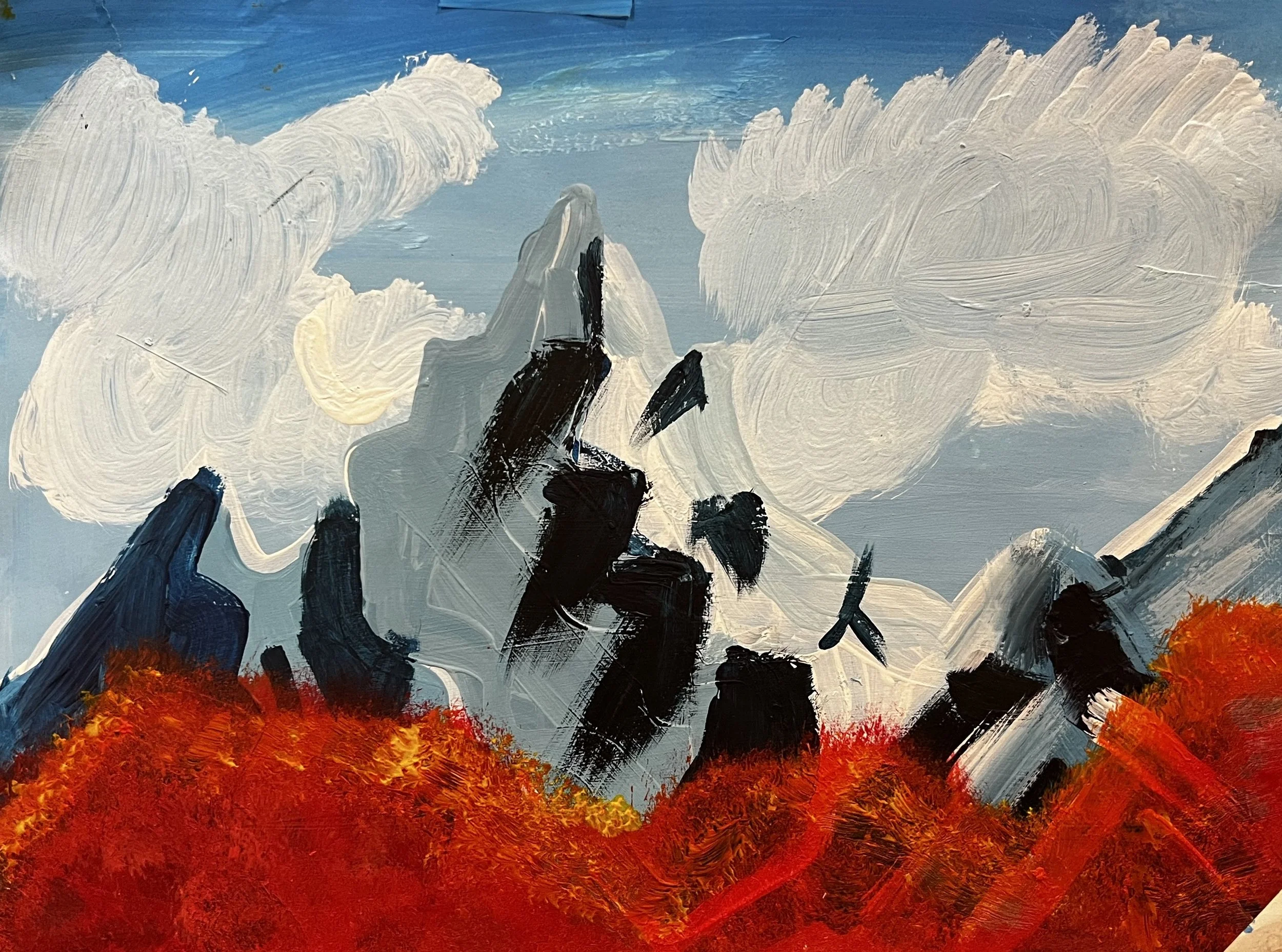 Snowy mountain flanked by red foliage