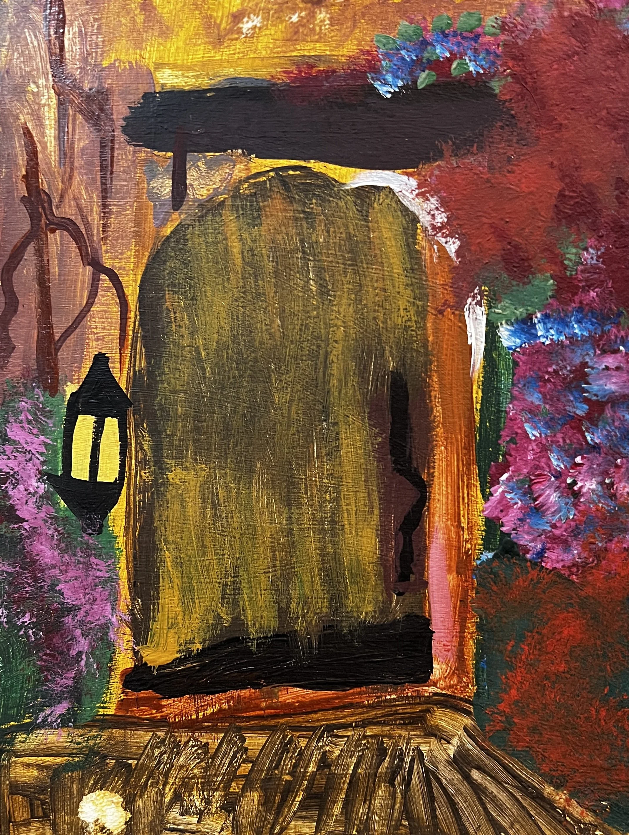 Big wooden door surrounded by flowerpots