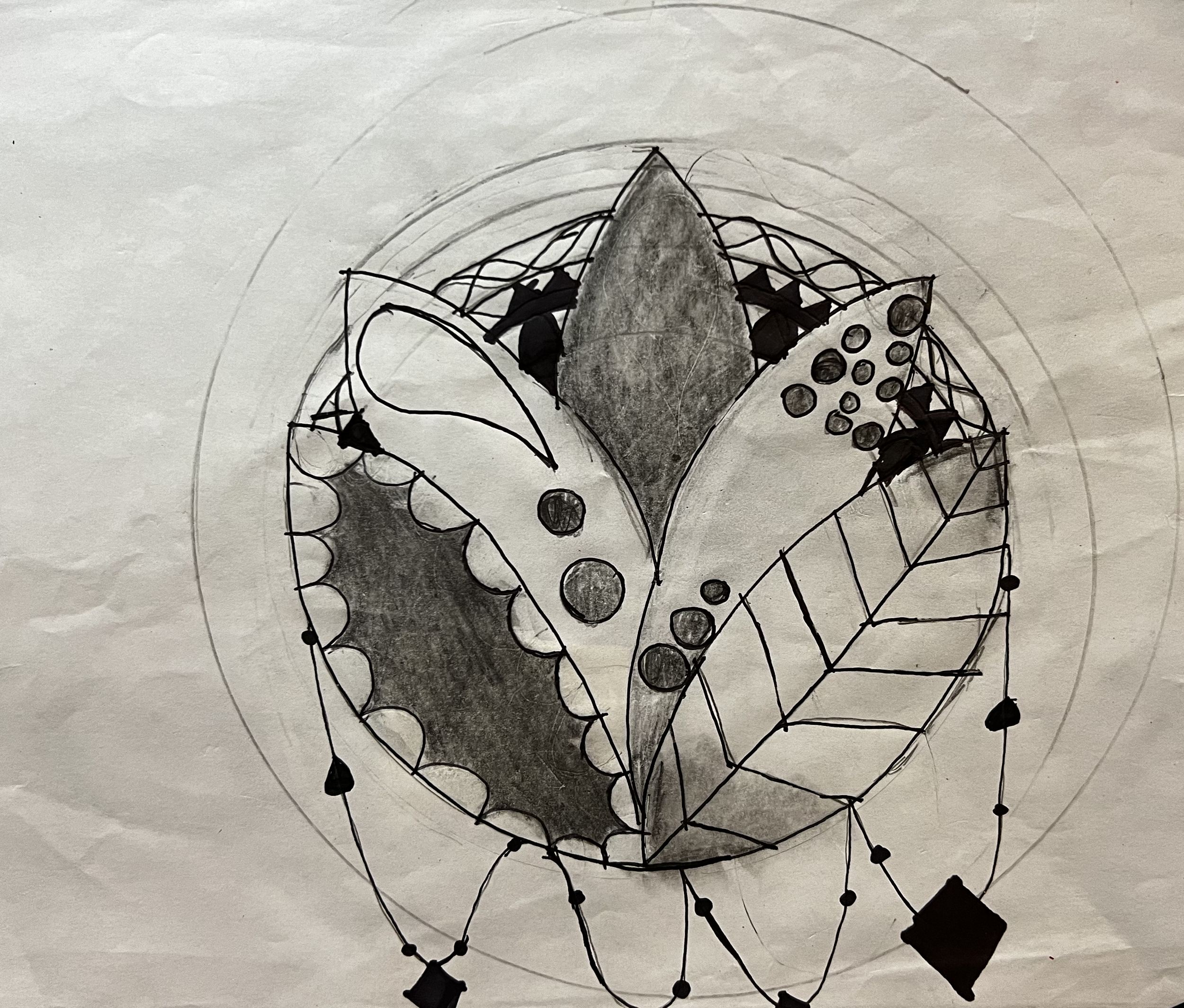 Flower design in a circle with hanging beads