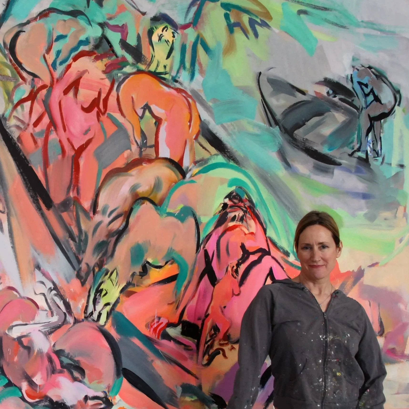 Photograph of a middle-aged woman with brown hair in front of a colorful, abstract mural painting.