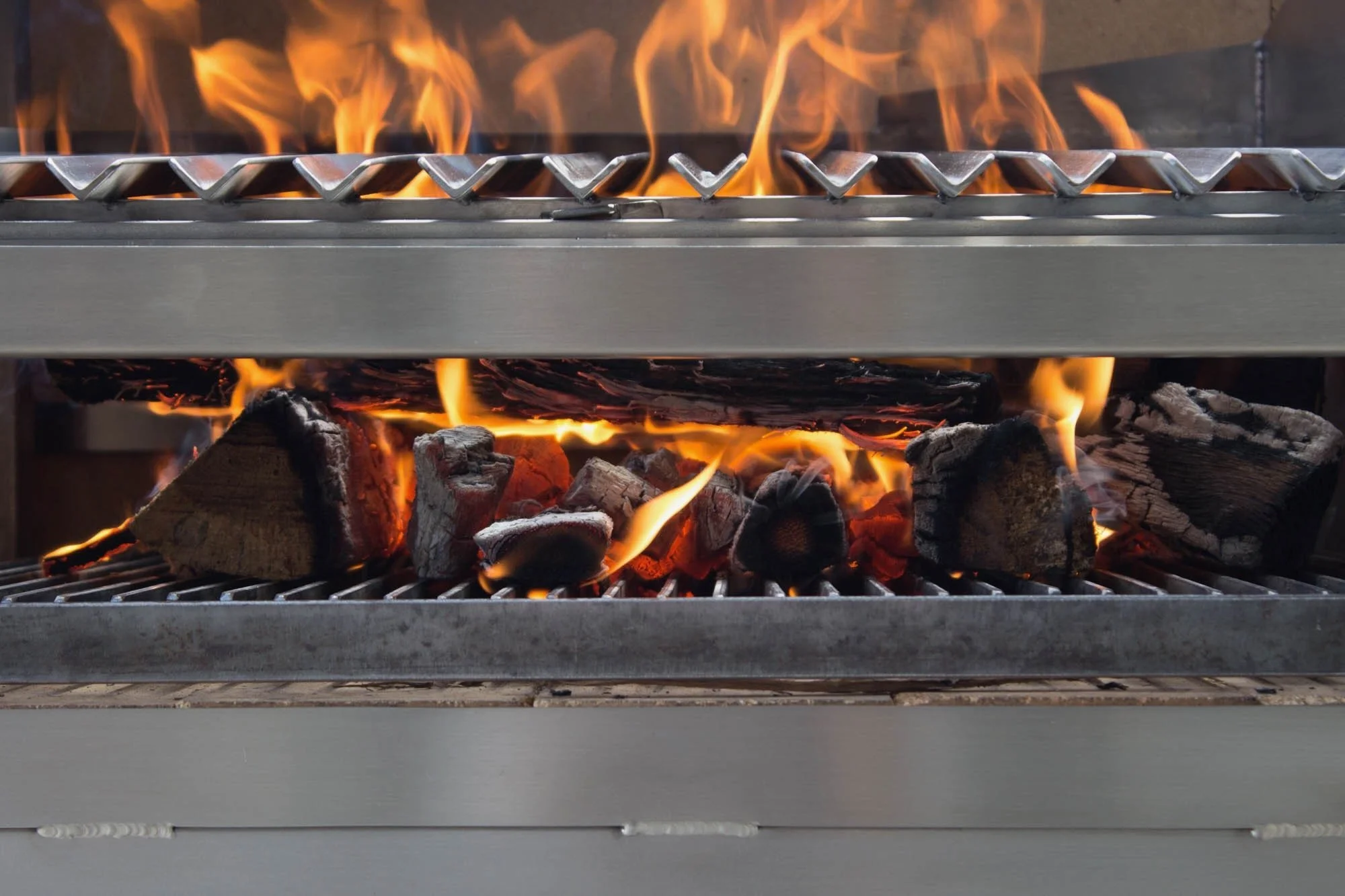 Most grills can't burn wood.
The steel warps. The airflow chokes. 
So they're built for charcoal, predictable, easy, safe.
We build for fire. Real splits. Flame to ember. The full arc.
Smoke, ember, char. The way it's supposed to taste.

#grillsbydem