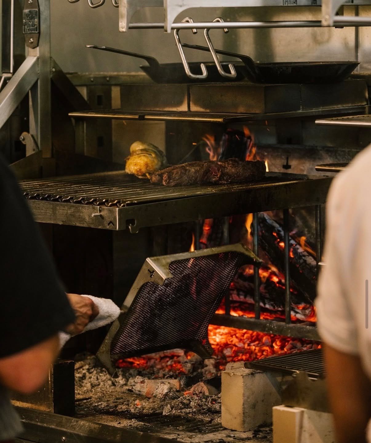 The fire doesn't care that you're 200 covers deep.
But the crew at @goldenhour.avl does. Steak over open flame, vegetables catching color, coals dialed in by hand - that's not luck. That's cooks who know their fire, on equipment built to hold it.
We 