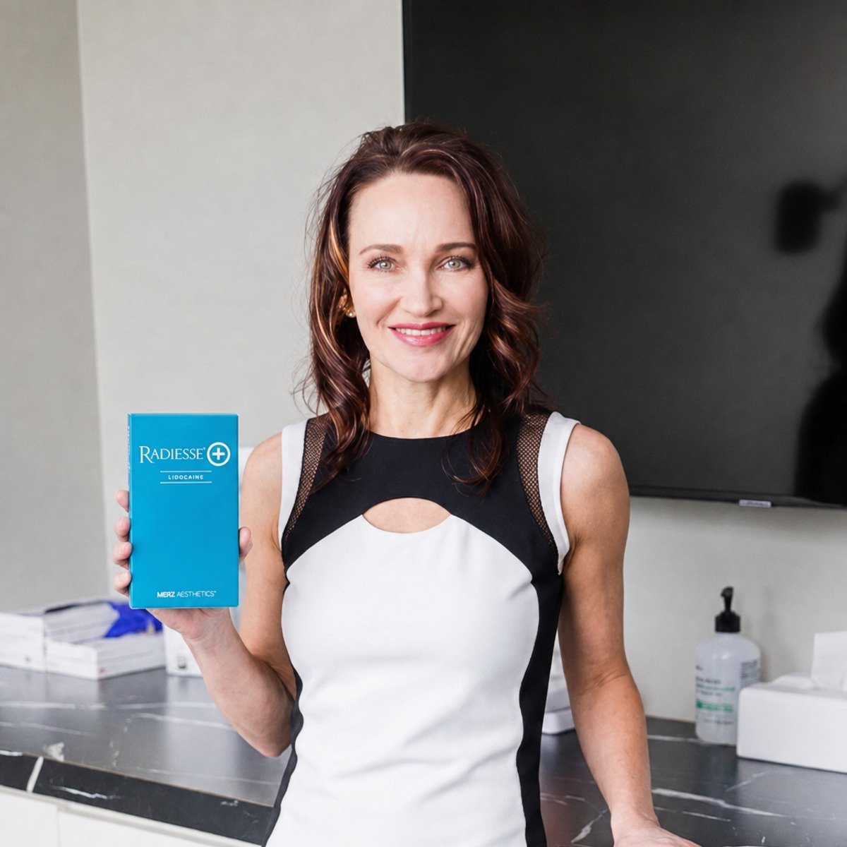 Dr. Alison Tendler holding a box of Radiesse at ARTisan Skin & Laser Center