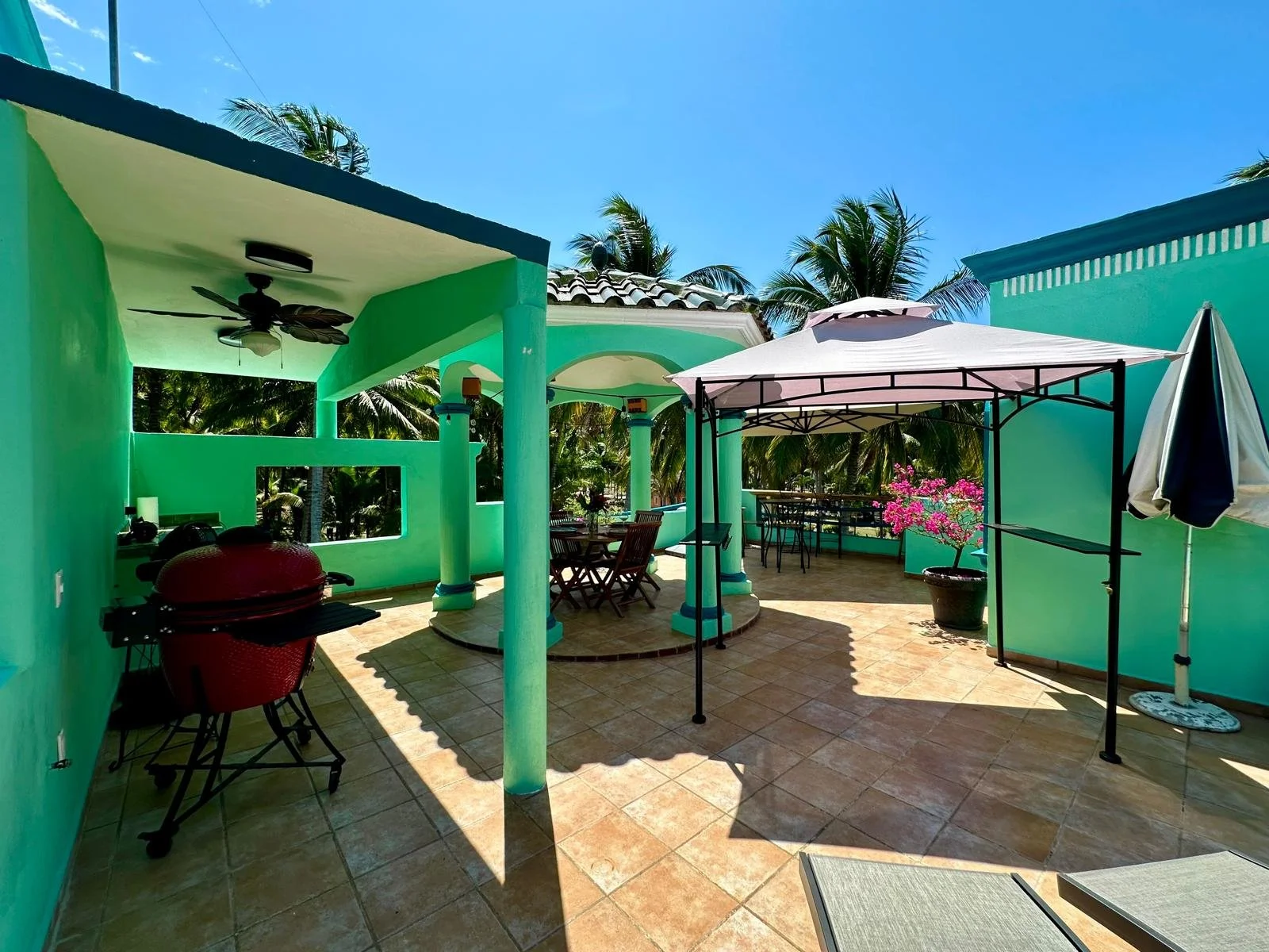 A grill, shade tent, and tile floored deck.
