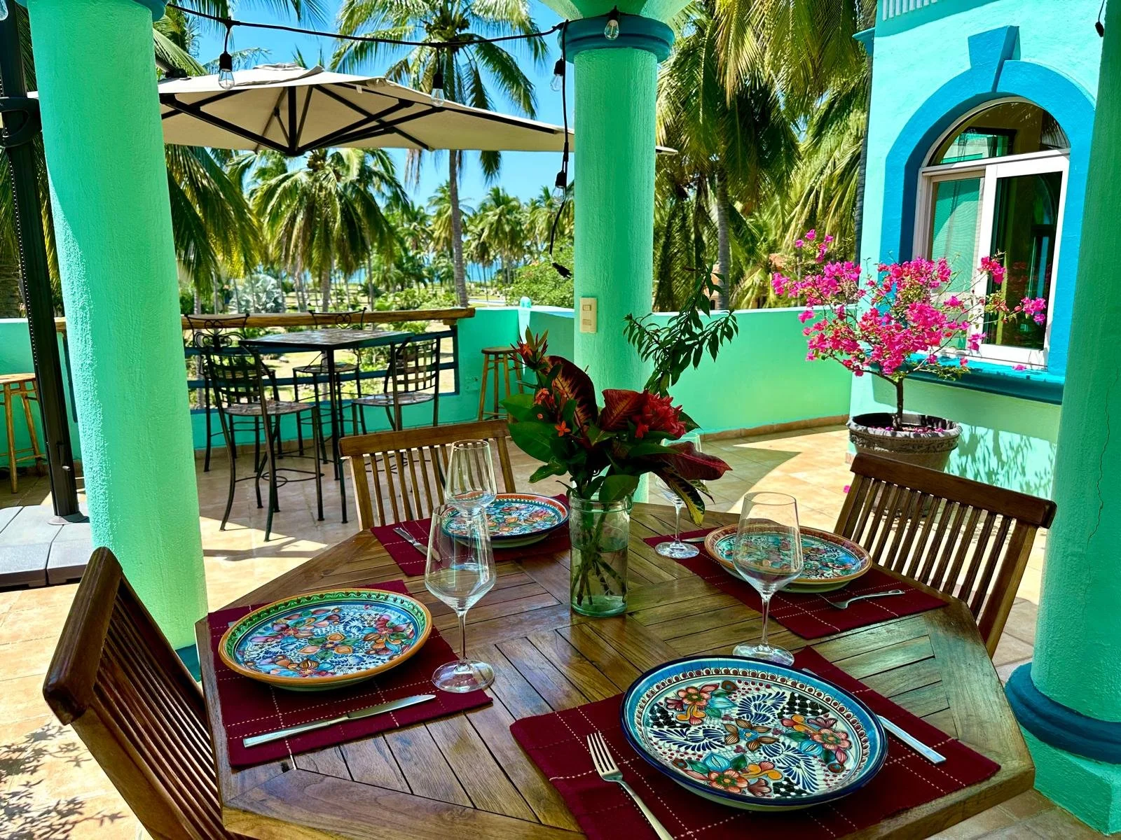 A table set for four on a rooftop deck.