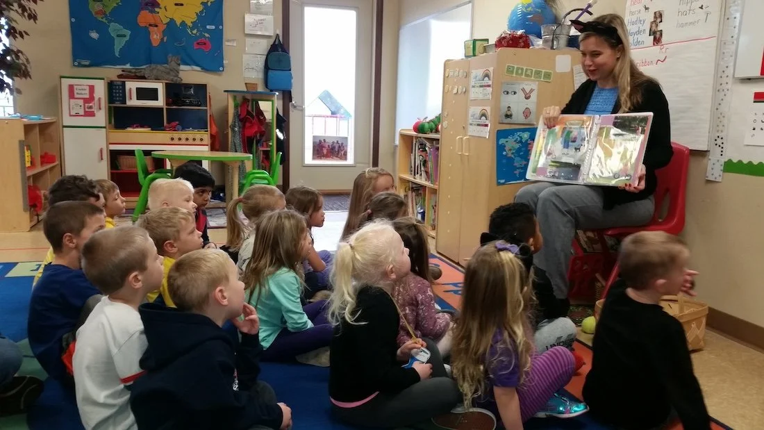 Corrine reading to children in classroom