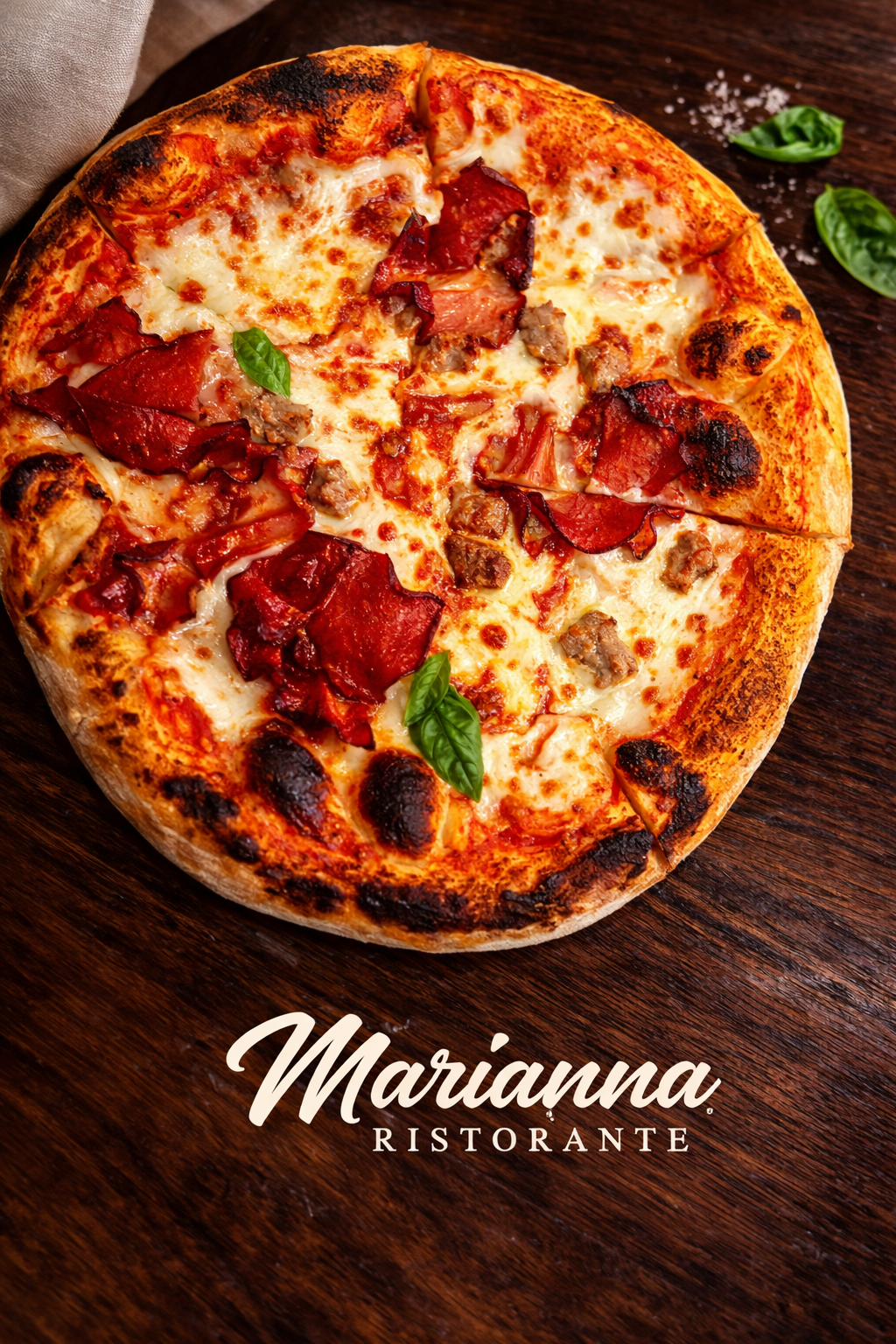 A close-up of a pizza with cheese, pepperoni, sausage, and basil leaves on a wooden surface, with Marianna Ristorante logo at the bottom.
