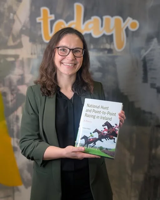 Photo of Dr Frances Nolan holding her book ' National Hunt and Point to Point Racing in Ireland.