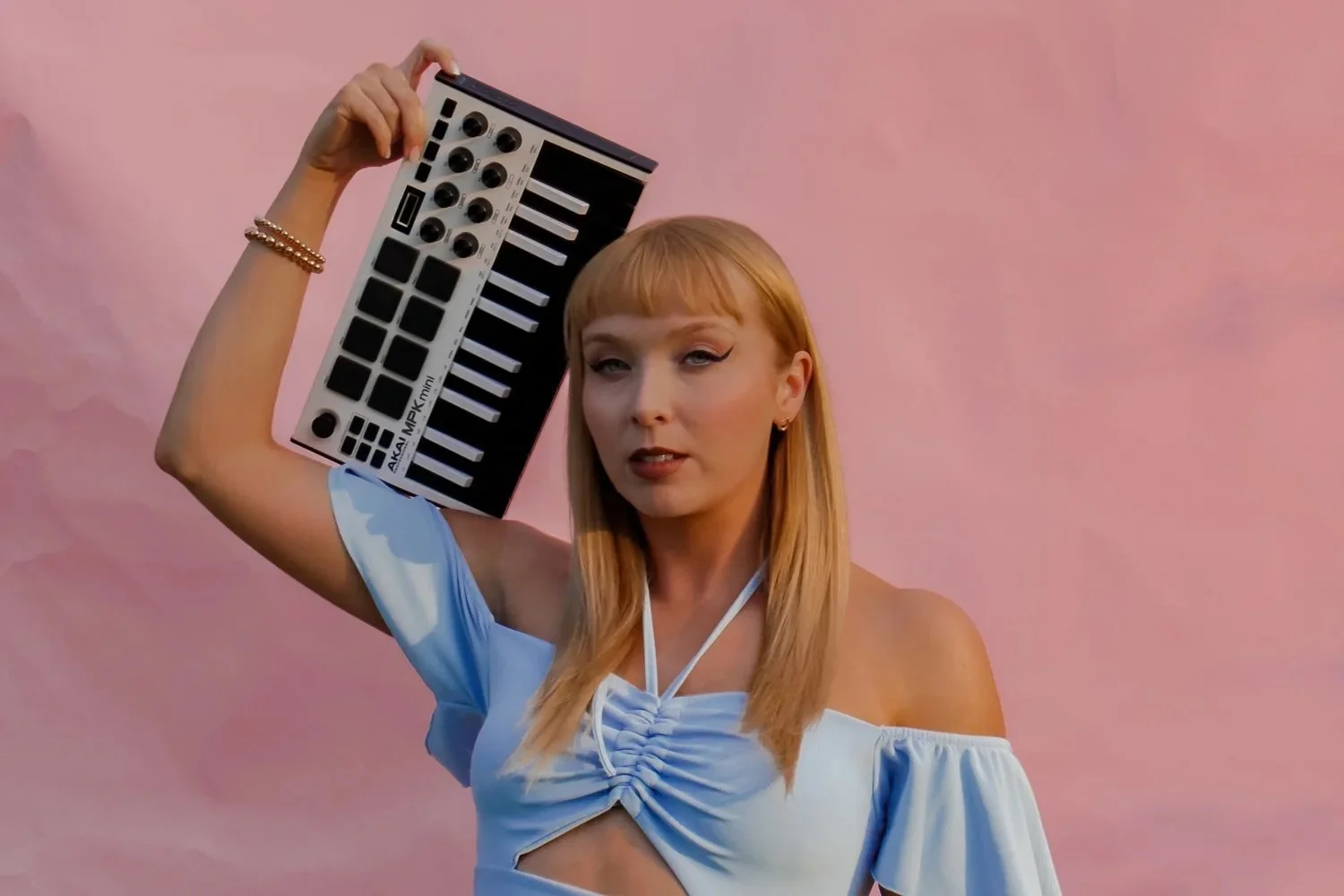 Image of Lisa Murray posing as a Taylor Swift lookalike holding up a mini sound recording device