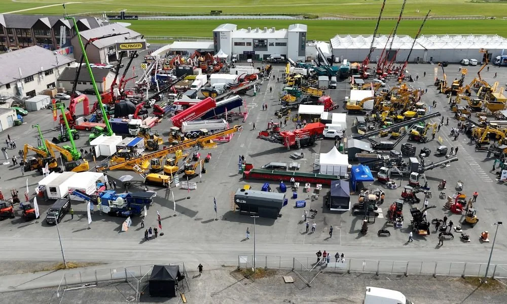 Aerial photo of the machines and displays to be expected at the event , car park full of colourful machines with large booms and trailers.