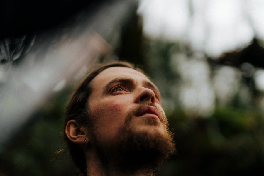 Photo of Séan looking to the sky listening to nature sounds
