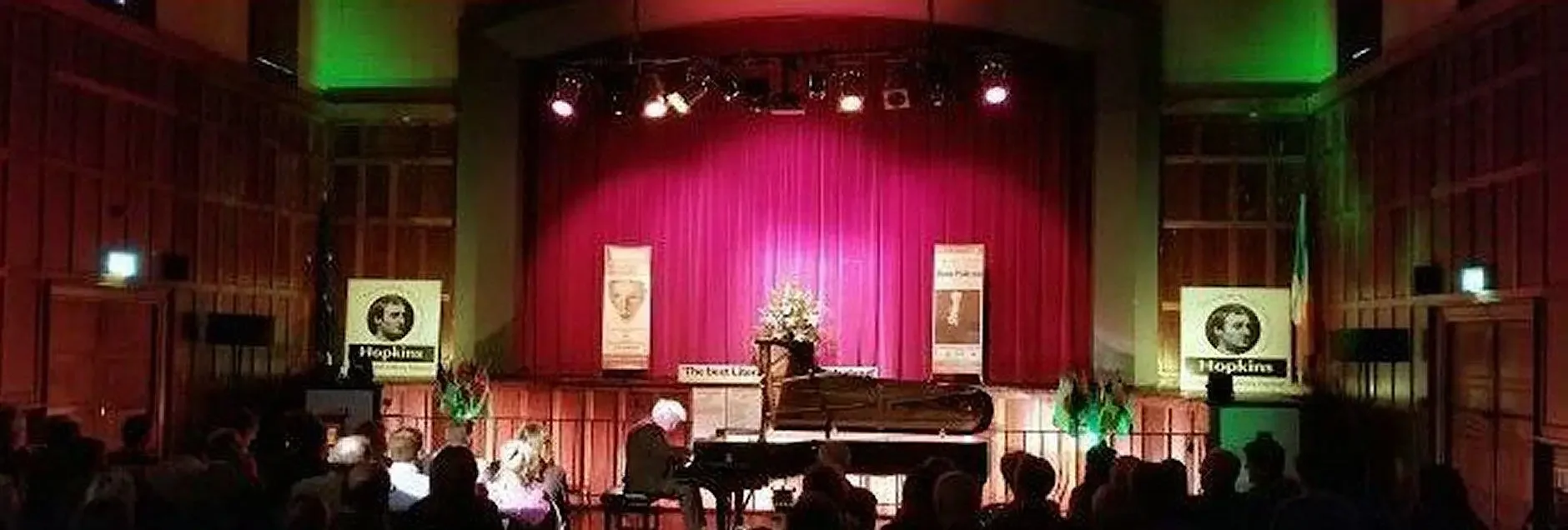 Gentleman playing piano on stage infront of audience