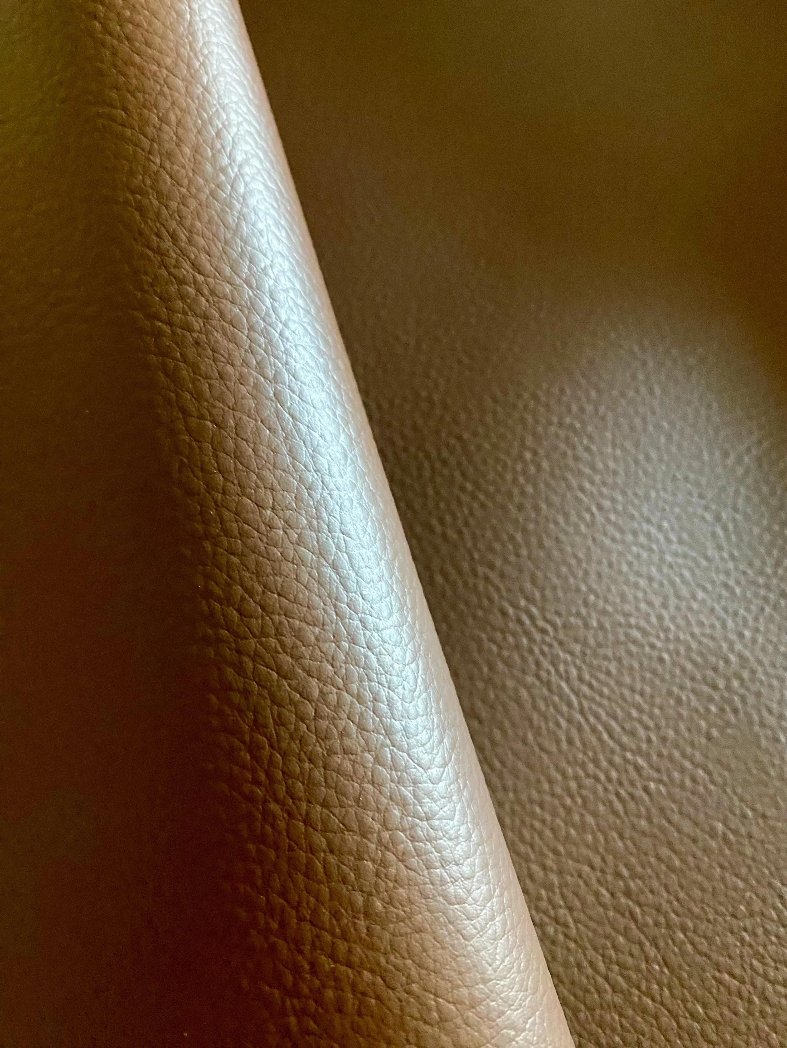 Textured brown Elevate™ is an innovative bio-based leather alternative developed by Uncaged Innovations.