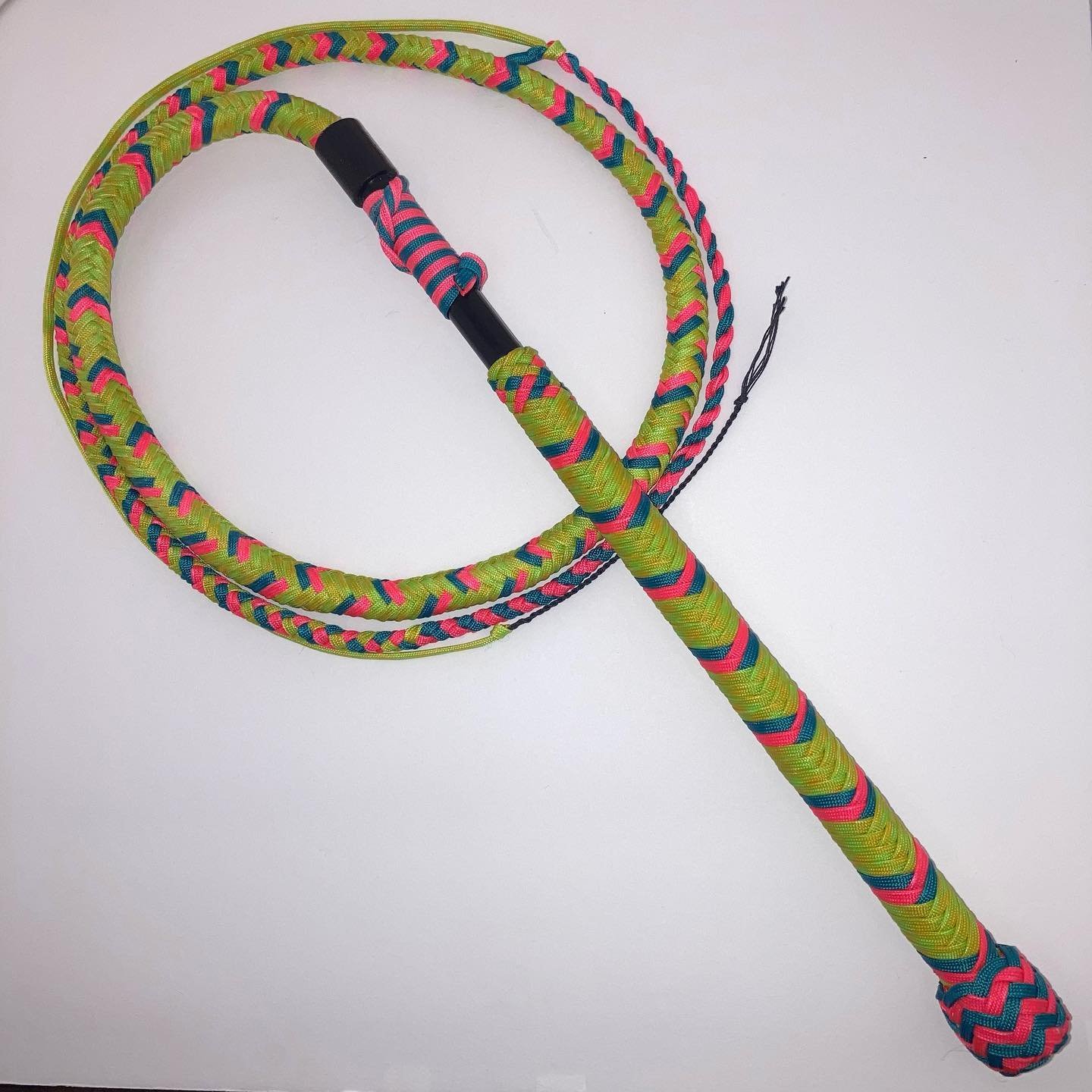 Colorful jump rope with pink, blue, yellow, and green woven pattern on a white background.