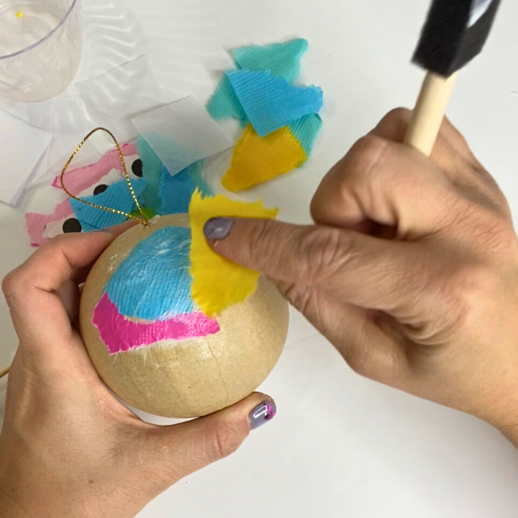 Paper mache Christmas ornament fully covered in colorful napkin decoupage