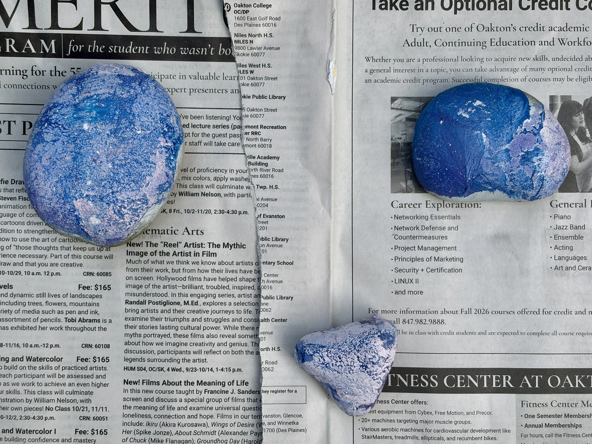 Marbled blue and lavender paint swirl left on the water's surface after pulling a hydro dipped rock