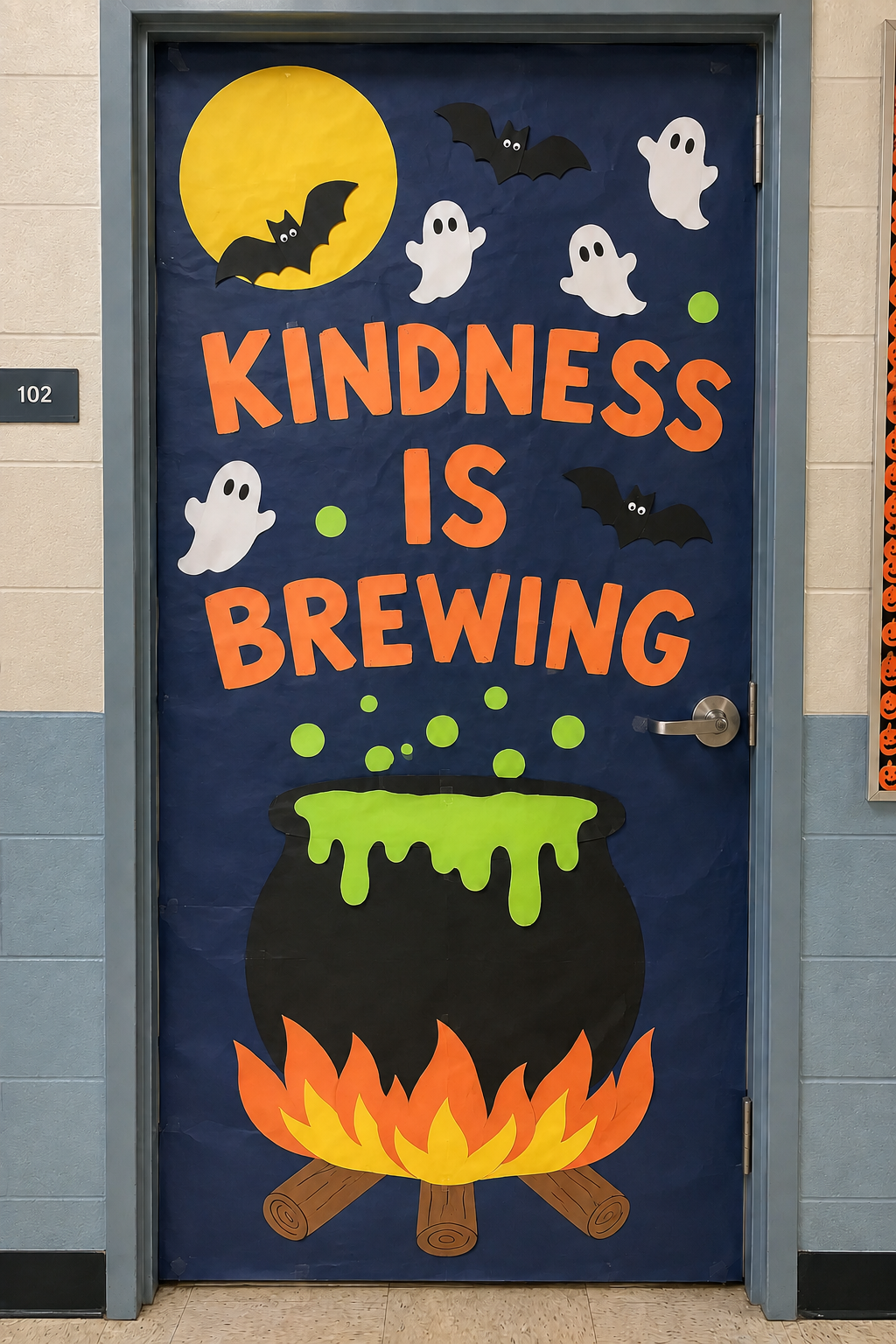 Construction paper cauldron and witch Halloween classroom door with a kindness message