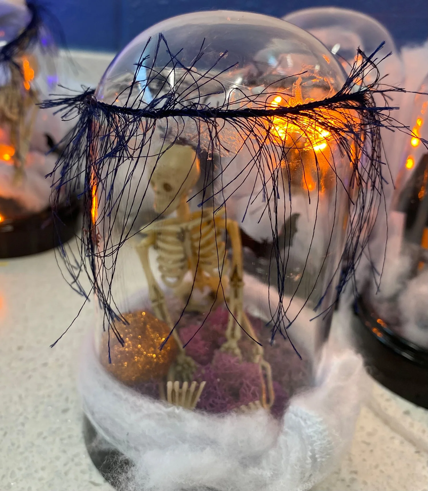 A Miniature Skeleton Scene with Fairy Lights