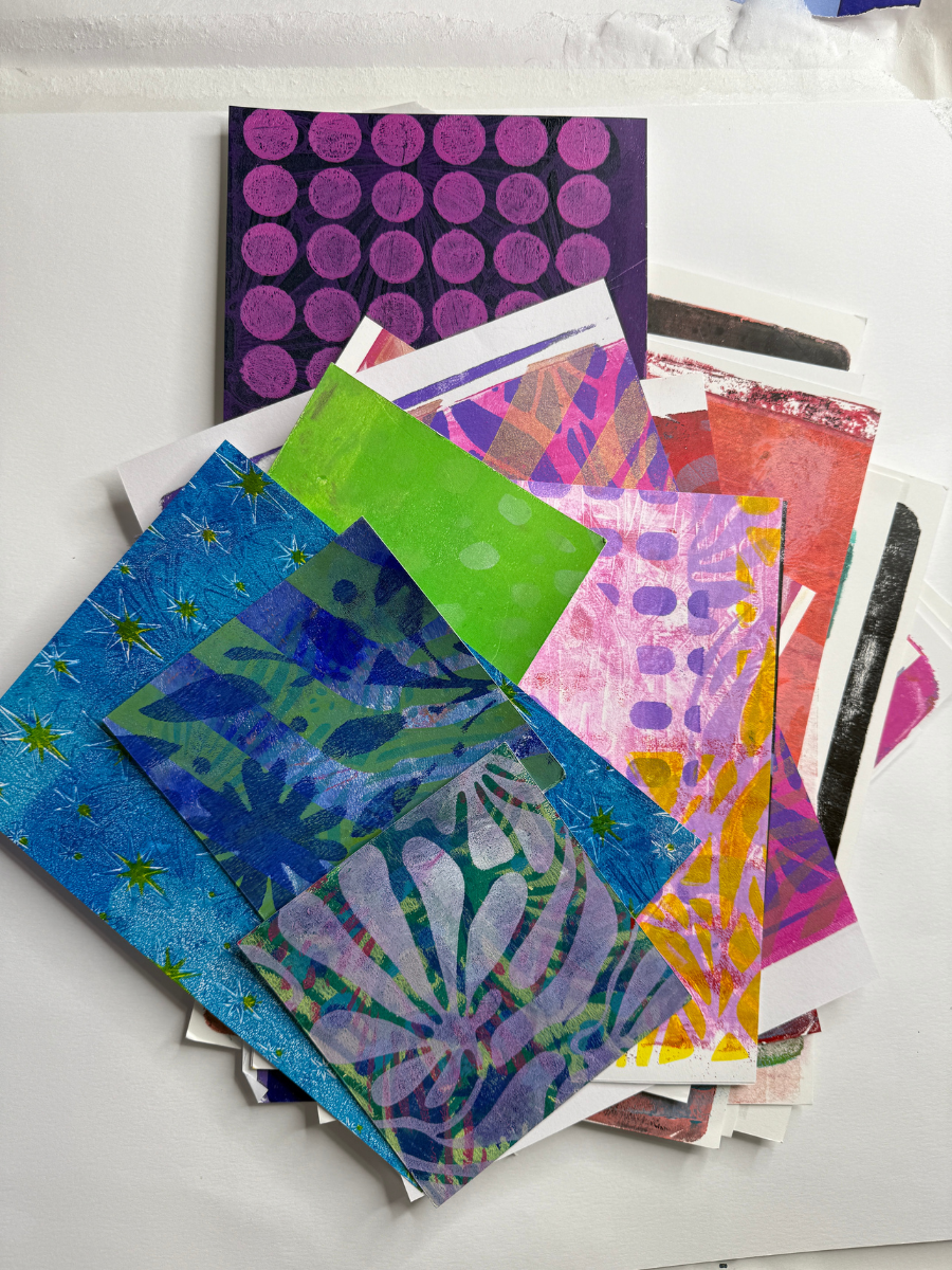 Stack of colorful gelli print papers in various patterns and textures for DIY butterfly crafts.