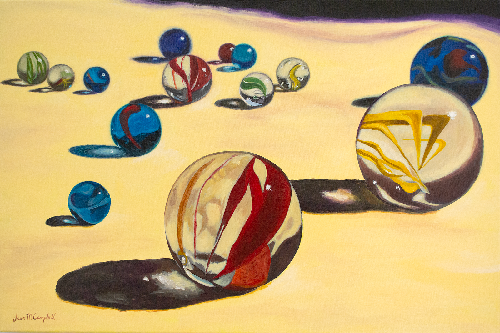 A battalion of marbles rolls forward. The early morning sun illuminates these colorful orbs, casting long shadows that are almost as beautiful as the marbles themselves.