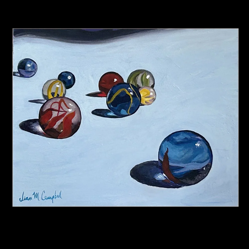 Laser print reproduction of a handful of marbles on a light blue tablecloth. Light passes through them, creating beautiful shadows with colorful glow spots.