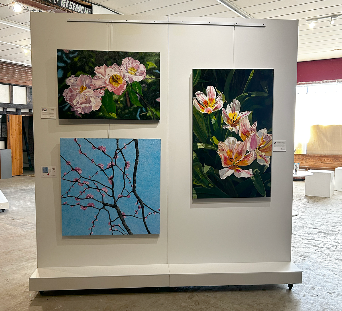 Three paintings on a panel wall at East Village Arts are a part of the "Work of Still" two-woman show of Ginger Wyatt and Jean Campbell.