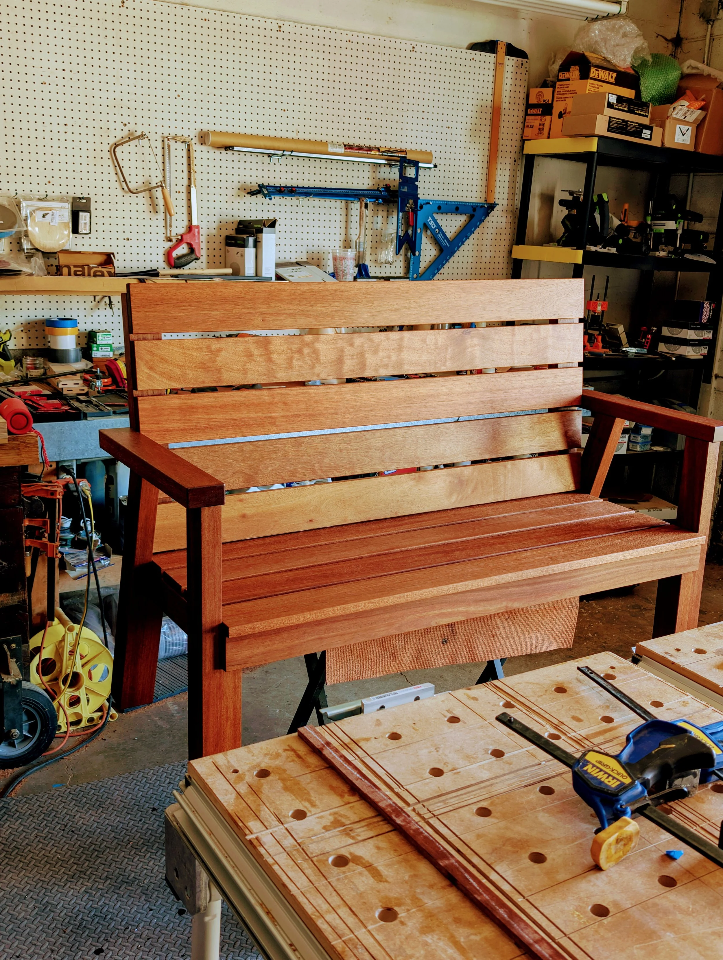 A mahogany bench made from reclaimed Honduras old growth mahogany.