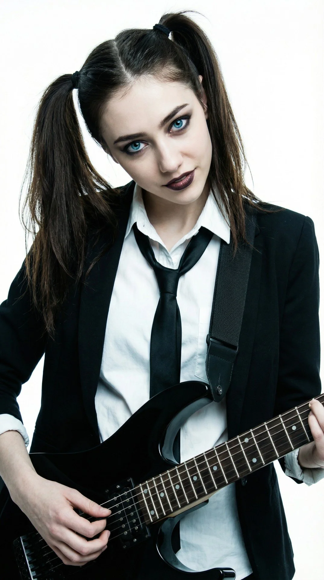 Lisa Renard, Pink Paradox post-hardcore band guitarist with her dark hair in pigtails, wearing a black suit jacket, white shirt, and black tie, playing a black electric guitar.