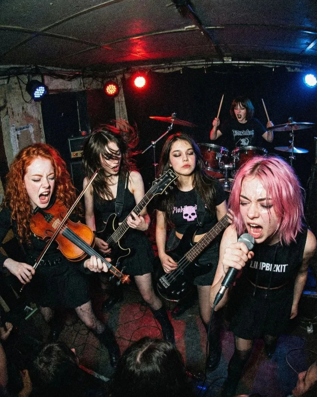 Pink Paradox all female metal band together live on stage.