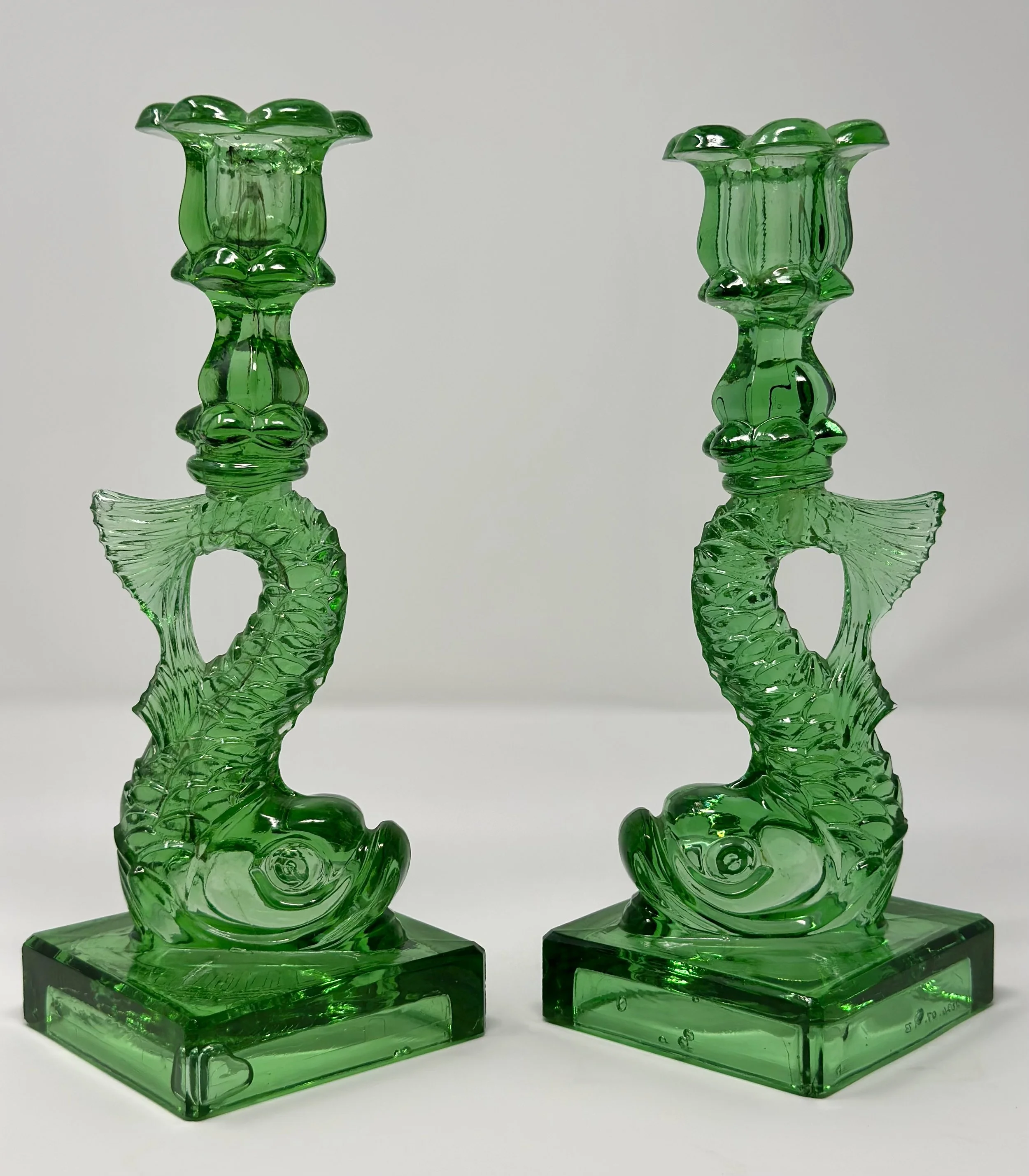 Why does the Sandwich Glass Museum have so many candlesticks shaped like strange-looking dolphins?