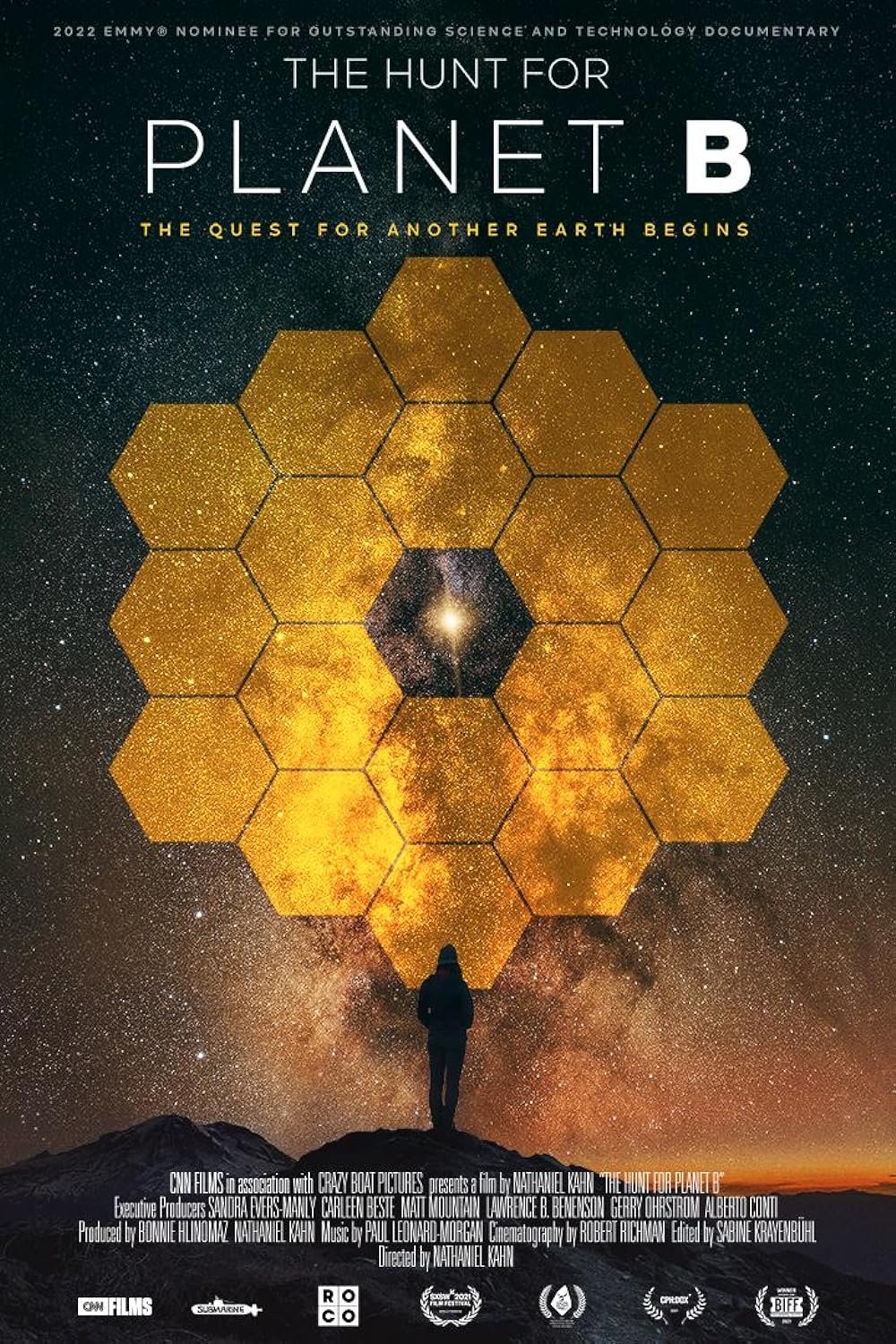 Movie poster for 'The Hunt for Planet B,' featuring a person standing on rocky terrain gazing at a starry night sky with galaxy and star formations, overlaid with a honeycomb pattern and the title above.