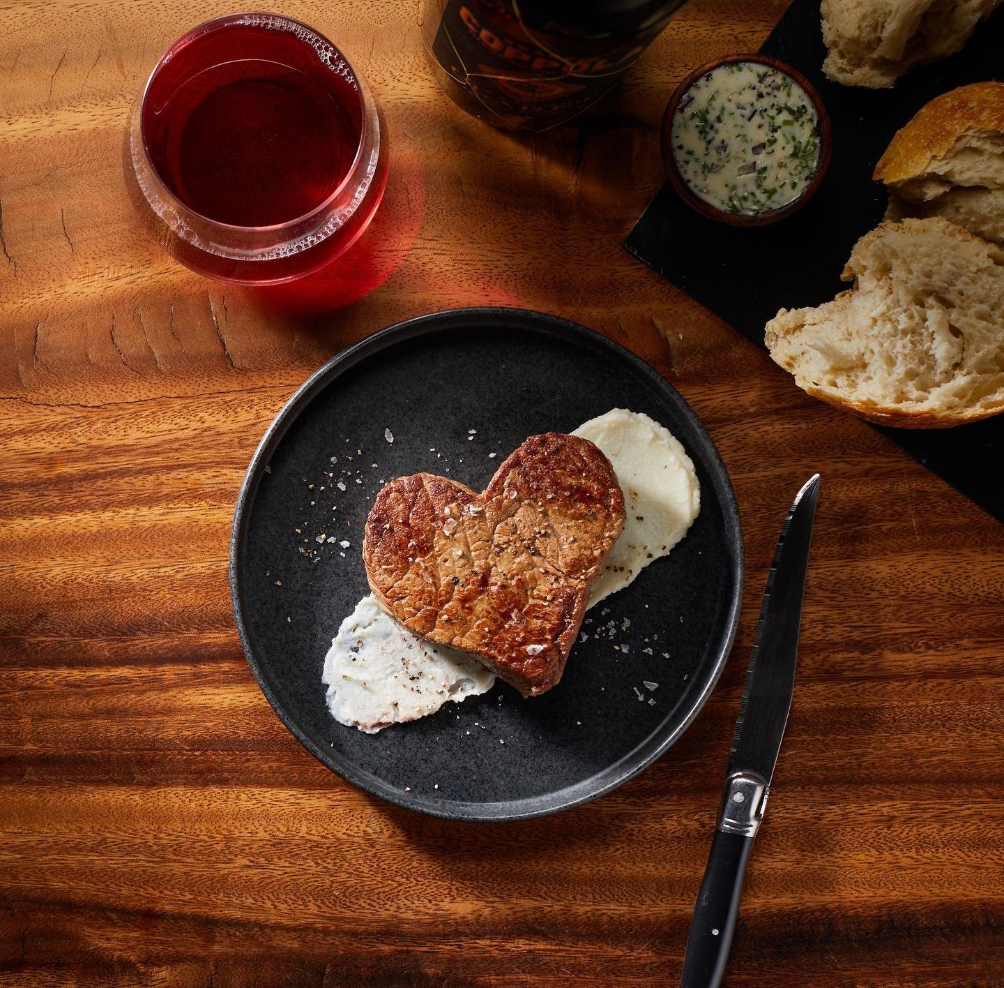 All you need is...#steak and #redwine and #bread... oh and a little compound #butter never hurts. #valentinesmeal #heartsteak #foodstylist #phoenixarizona @adriandelsiphoto