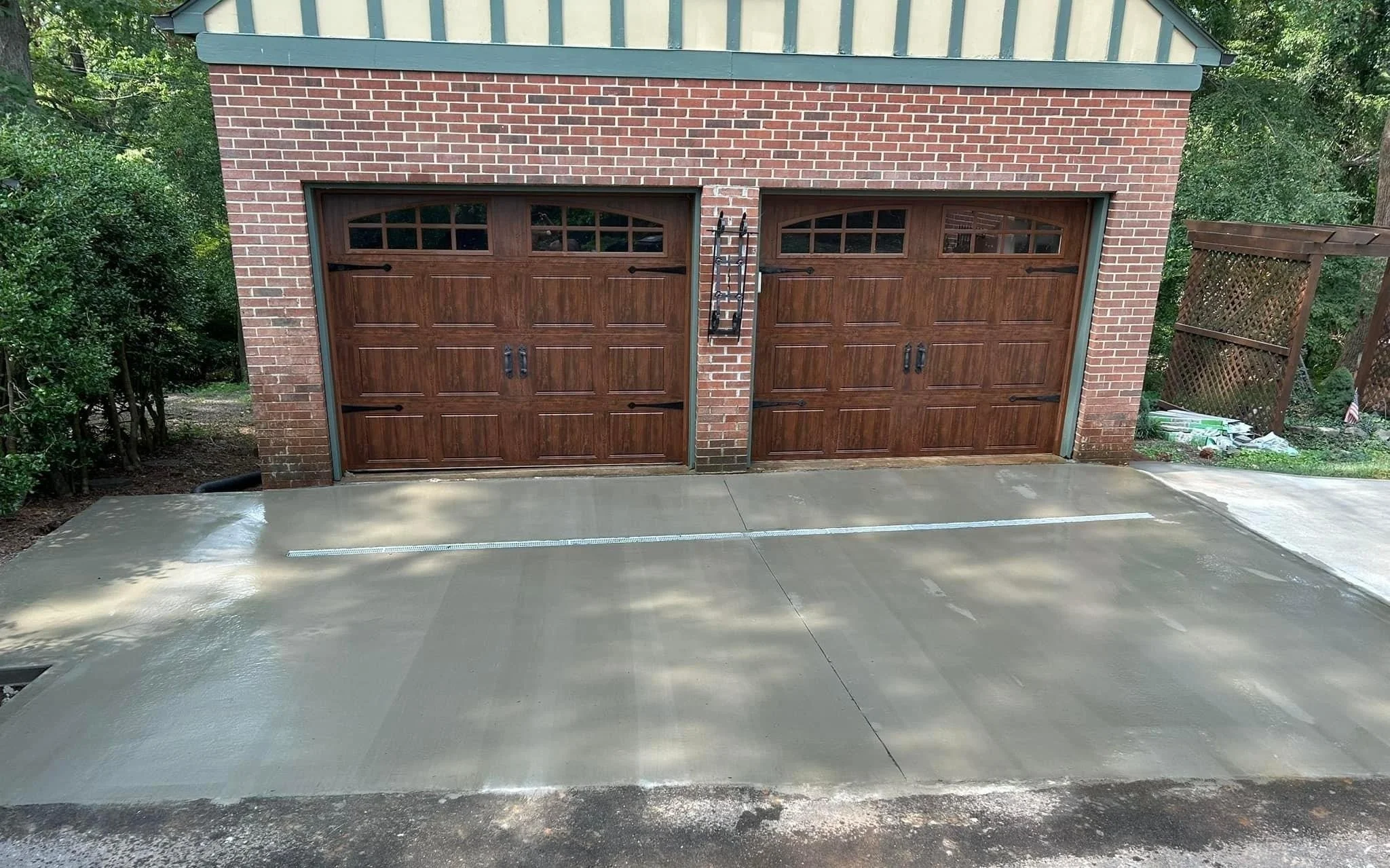 Finished driveway outside of garage w:drain.jpg