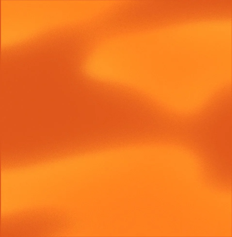 Close-up of a shiny, smooth orange metallic surface.