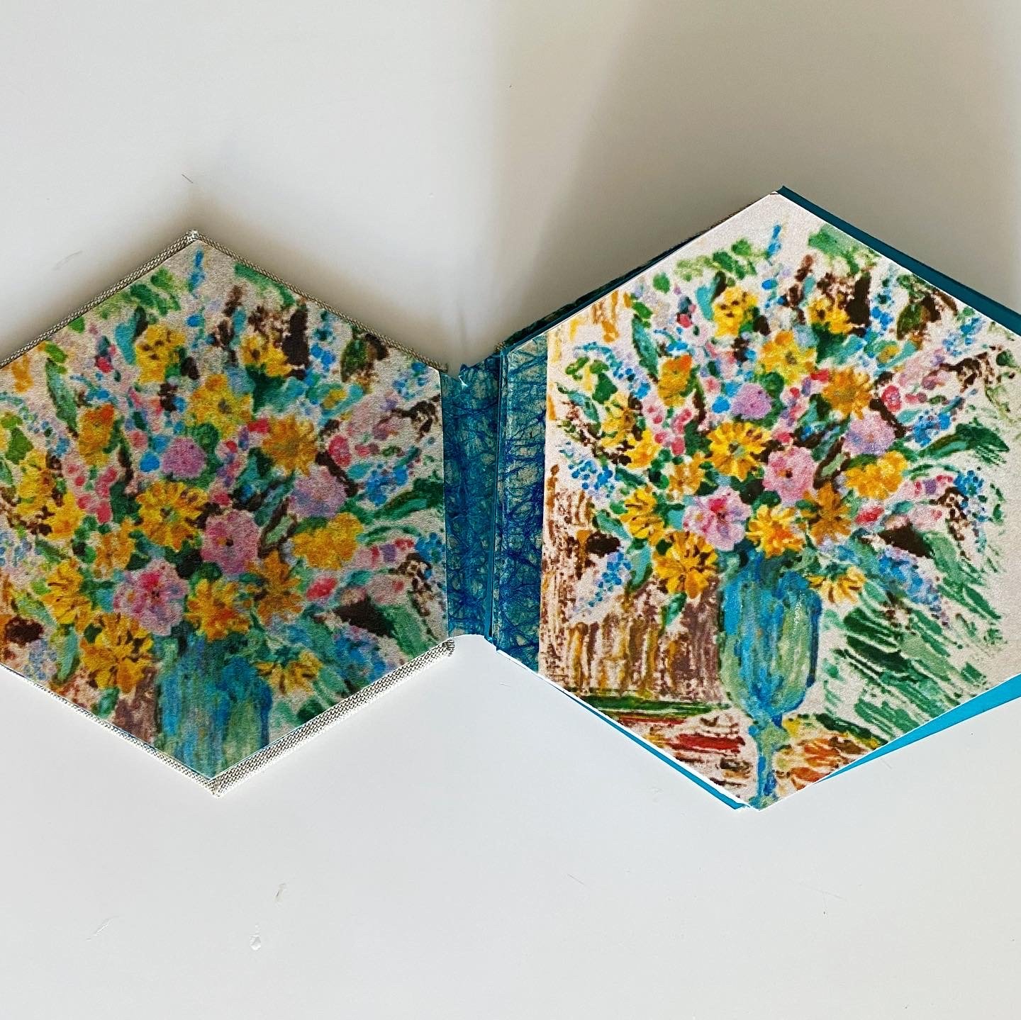 This hexagonally-shaped program features prints of some of her still life paintings, such a contrast to her sharp mirrored-works.