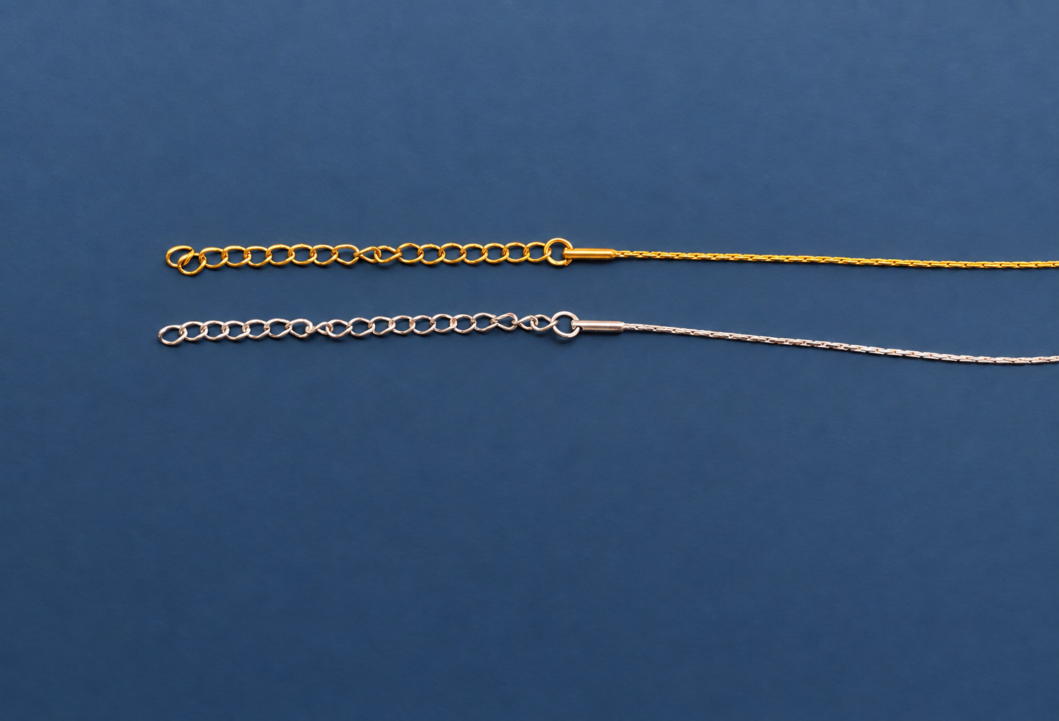 Gold and silver chains on slate blue.png